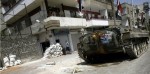 La Règle du Jeu - char_syrie Un char stationné dans une rue de Homs (c) AFP