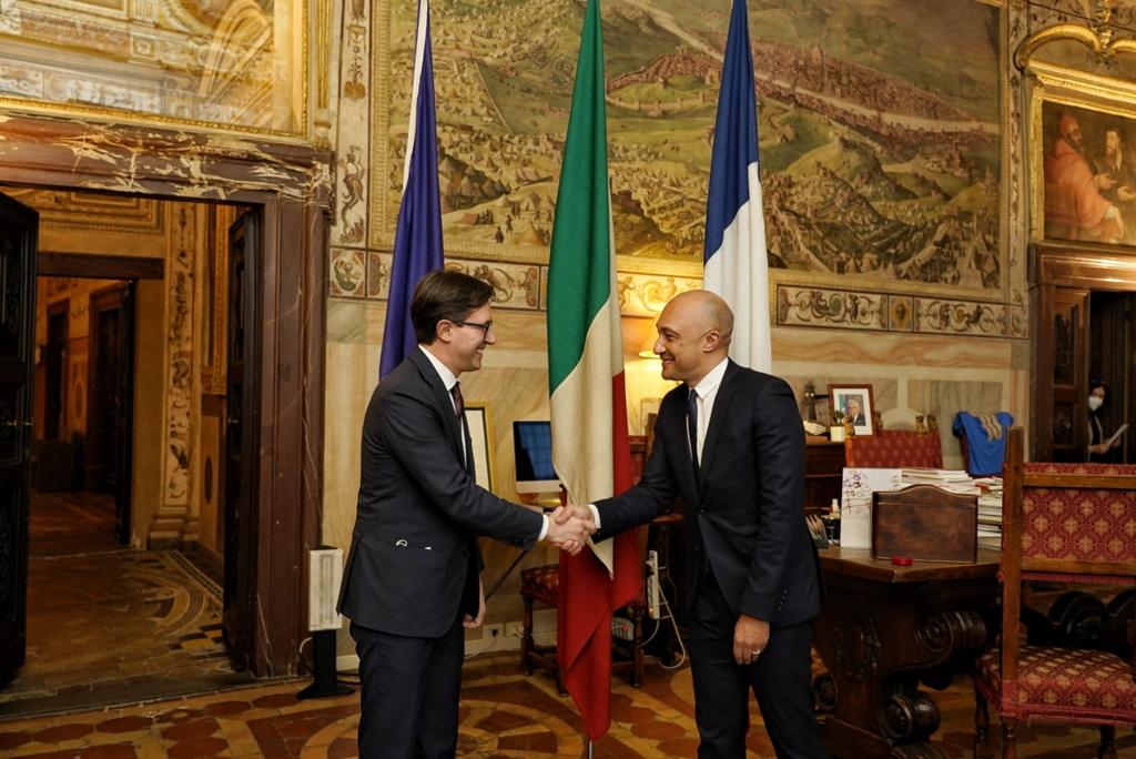 Dario Nardella, le maire de Florence, et Arnaud Ngatcha se serrent les mains.