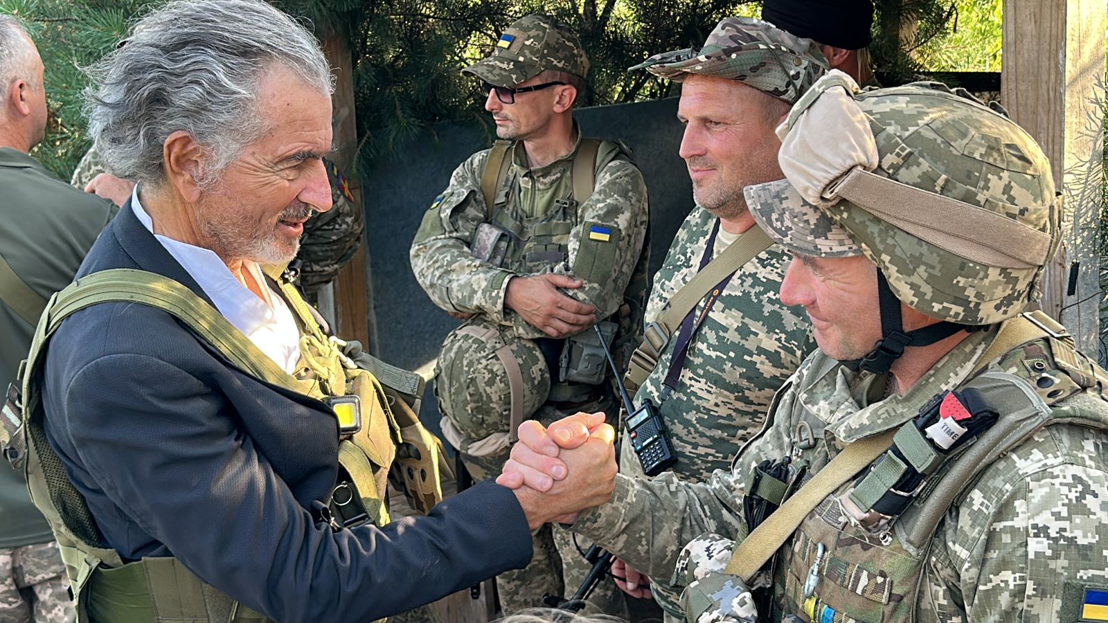 Le philosophe serre la main d'un soldat Ukrainien lors d'un reportage sur le front ukrainien contre la Russie.
