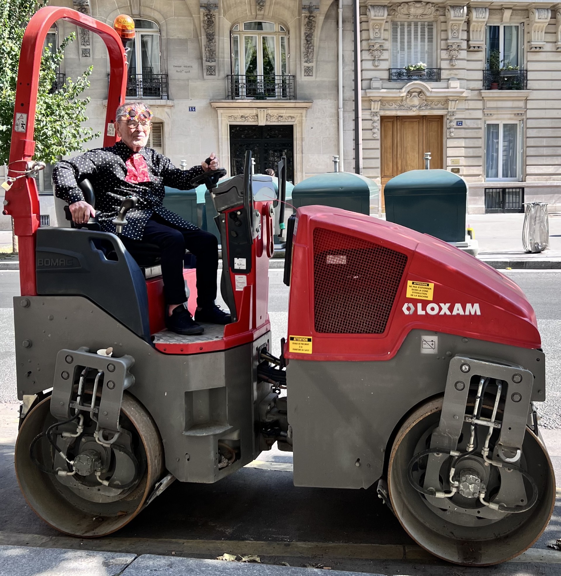 Fernando Arrabal est assis sur un rouleau tandem dans une rue de Paris.